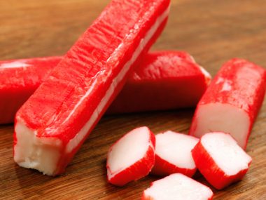 Surimi crab stick isolated on wood table